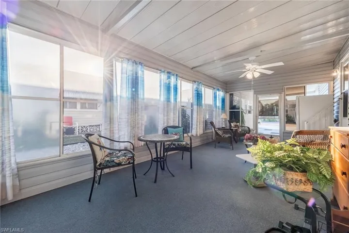 Sunroom with ceiling fan and wood ceiling