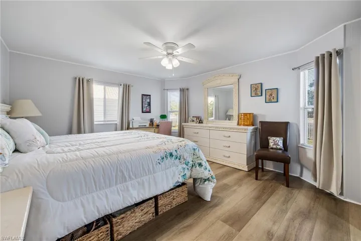 Bedroom with wood finished floors and ceiling fan