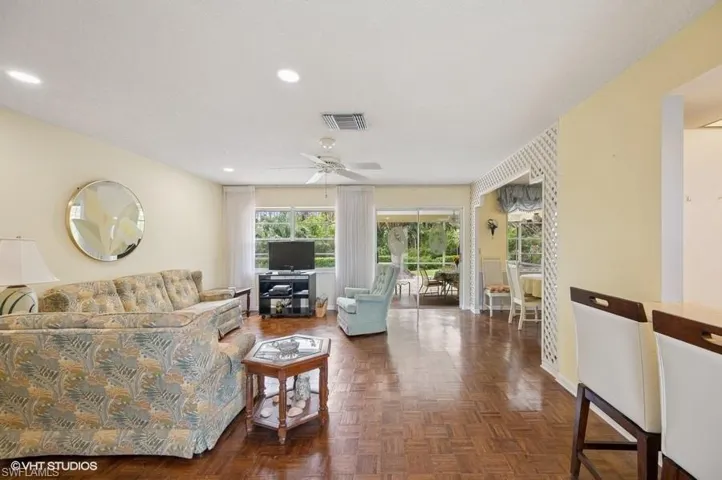 Living area featuring baseboards, visible vents, recessed lighting, and a ceiling fan