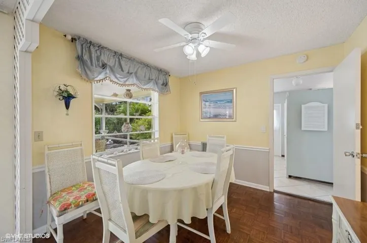 Dining space with a ceiling fan and a textured ceiling