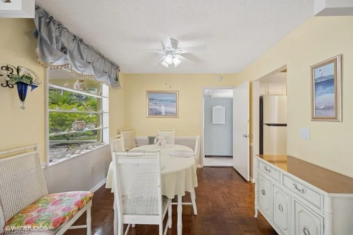 Dining area featuring a textured ceiling, baseboards, and ceiling fan