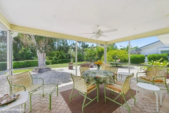 View of patio with ceiling fan and outdoor dining space