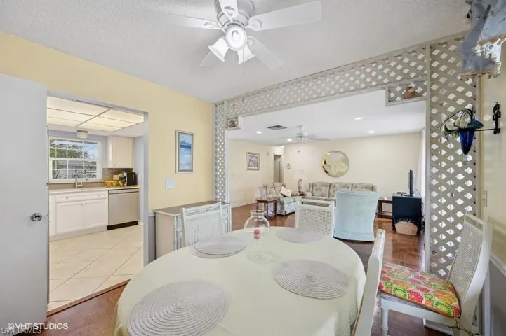 Dining area with visible vents, ceiling fan, light tile patterned floors, and a textured ceiling