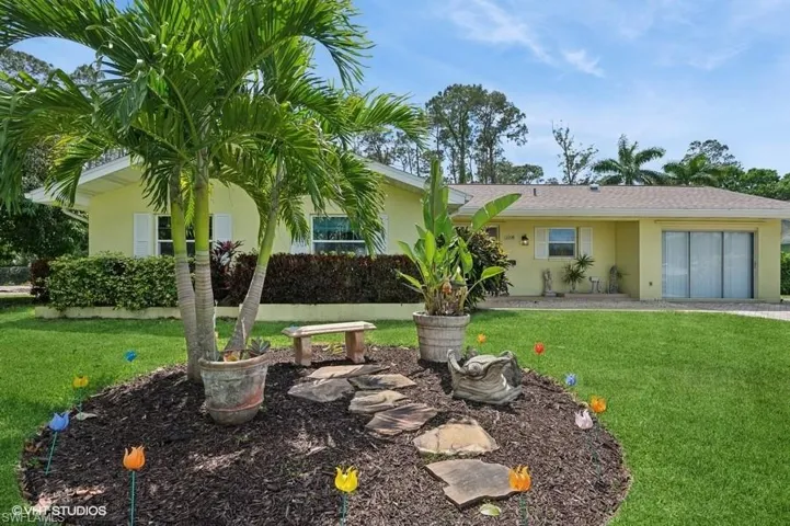 Ranch-style home featuring a front yard and stucco siding