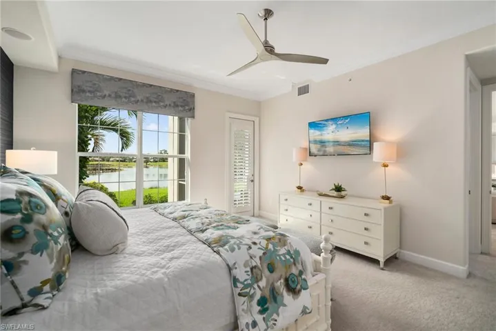 Bedroom featuring crown molding, light carpet, and ceiling fan