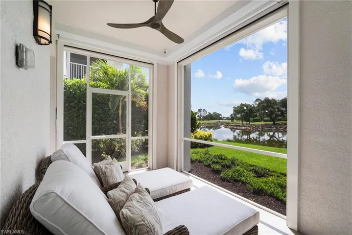 Sunroom / solarium featuring a water view, a wealth of natural light, and ceiling fan