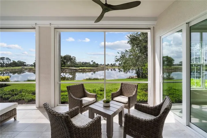 Sunroom featuring a water view, ceiling fan, and a wealth of natural light