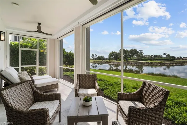 Sunroom featuring a water view and ceiling fan