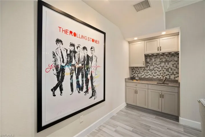 Room details featuring sink and tasteful backsplash