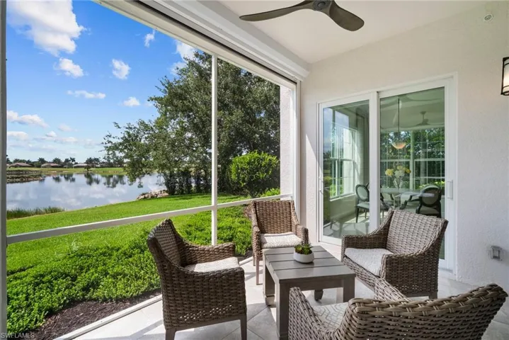 Sunroom with a water view and ceiling fan