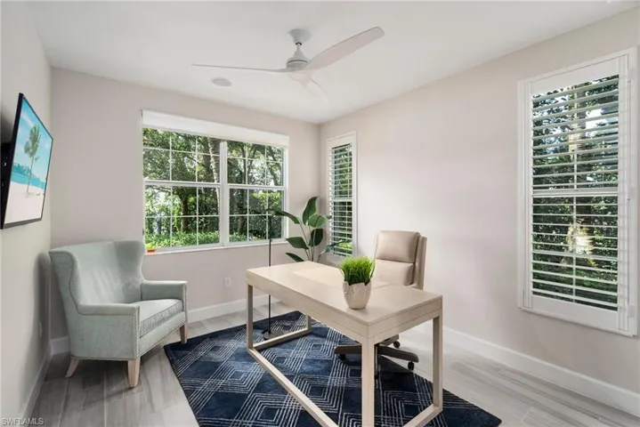 Office featuring wood-type flooring, ceiling fan, and plenty of natural light