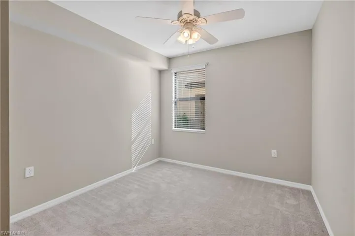 Unfurnished room with carpet and ceiling fan