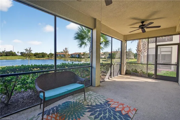 Sunroom featuring a ceiling fan, a water view, and healthy amount of natural light