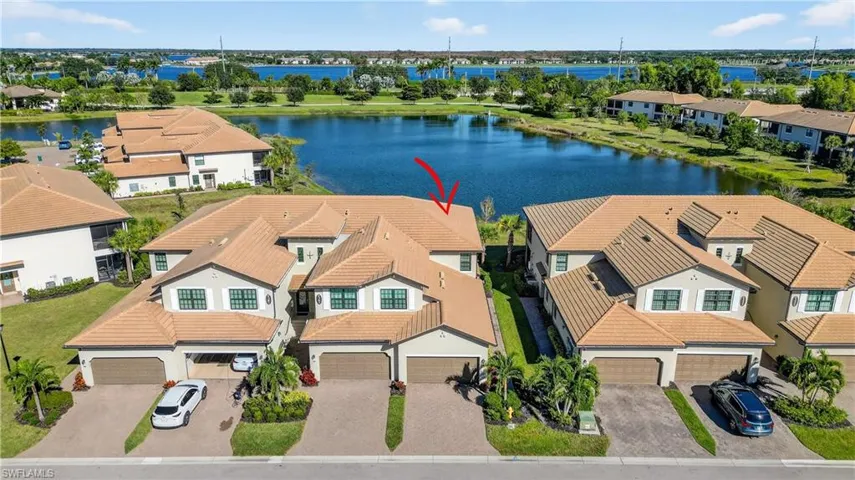 Aerial perspective of suburban area featuring a large body of water