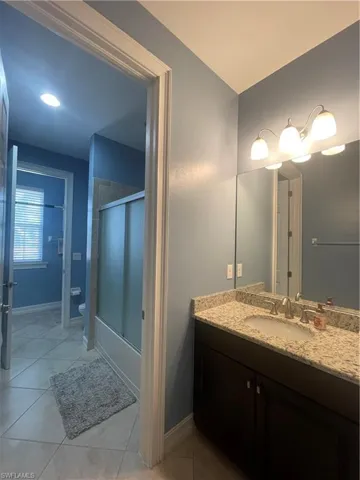 Guest bathroom serving bedroom 3 and 4 with two vanities.