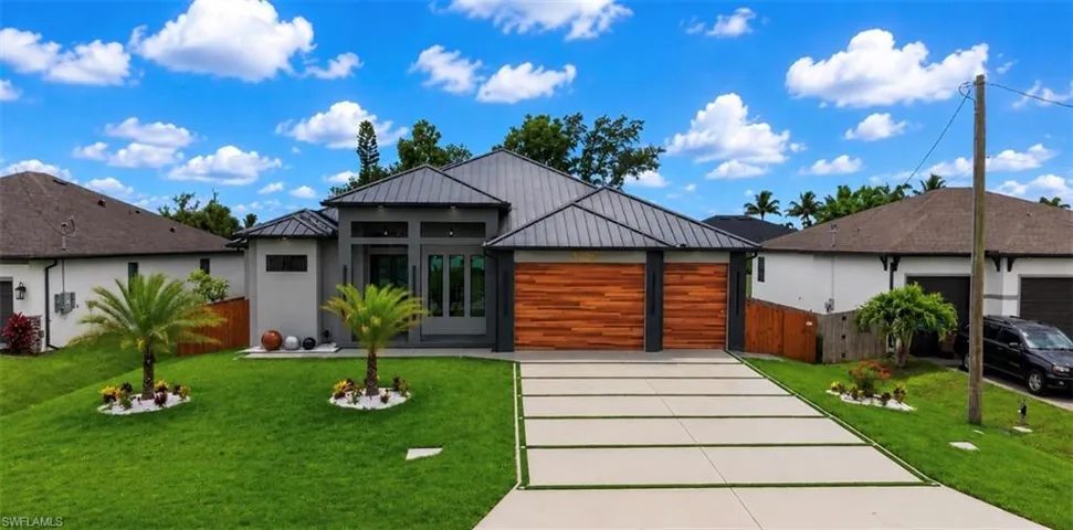 Modern architectural design with a dark metal roof and light gray stucco exterior