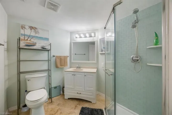 Bathroom featuring vanity, a stall shower, and light tile patterned flooring