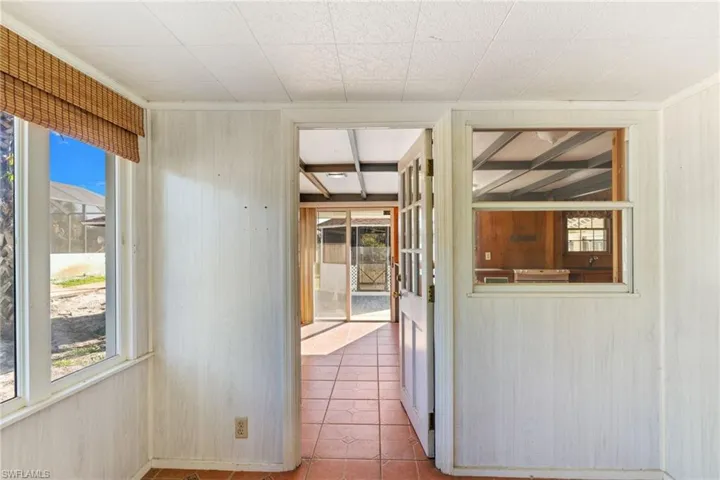 Corridor featuring wooden walls and light tile patterned floors