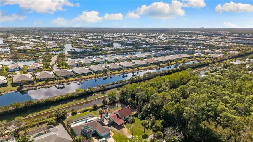 Aerial view of residential area featuring a large body of water