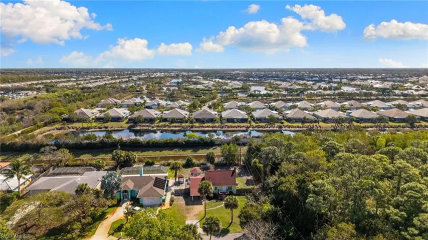 Aerial perspective of suburban area featuring a nearby body of water