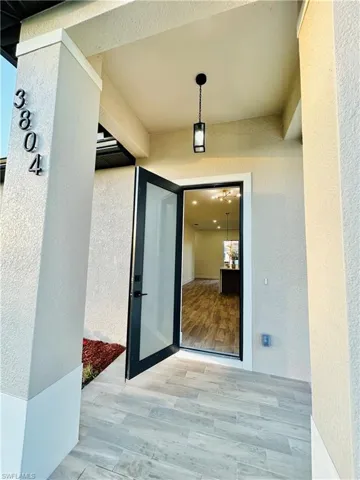 View of exterior entry with stucco siding