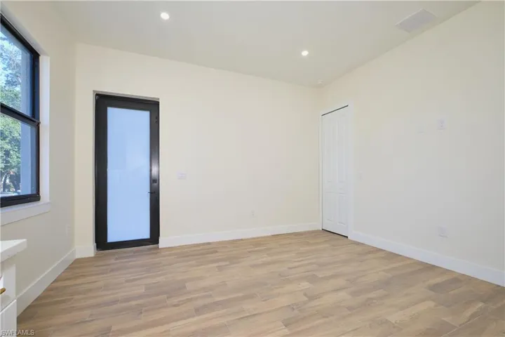 Spare room featuring light wood-type flooring and recessed lighting
