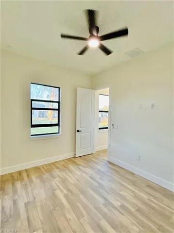 Unfurnished room featuring light wood-style floors and ceiling fan