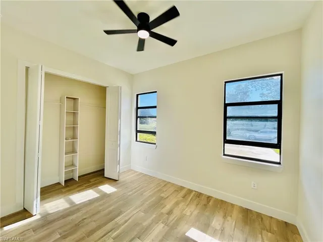 Unfurnished bedroom with light wood finished floors, a closet, and ceiling fan