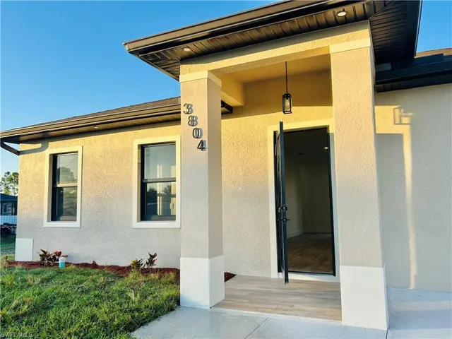 Property entrance with stucco siding