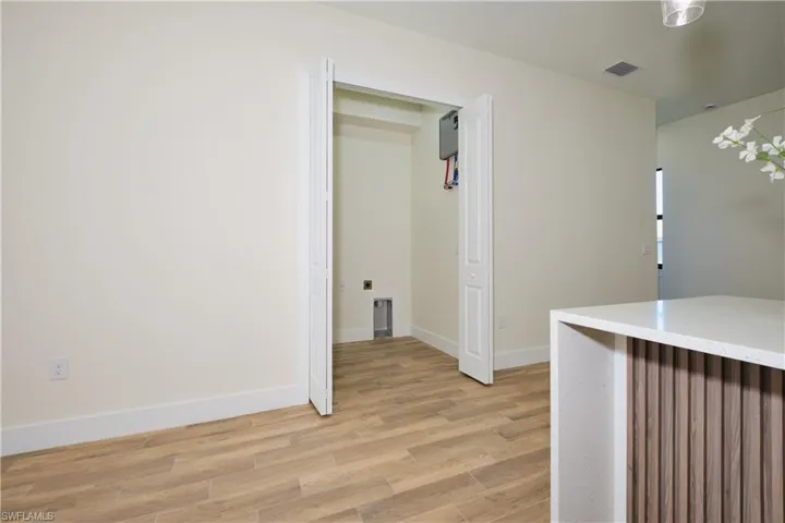 Hall featuring light wood-type flooring and baseboards