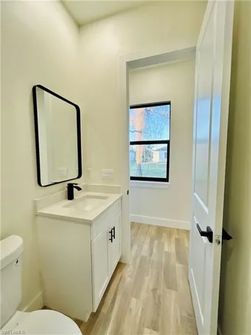 Bathroom featuring vanity and light wood finished floors