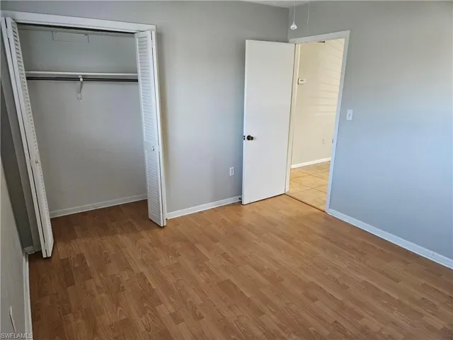 Unfurnished bedroom featuring a closet and light wood-type flooring