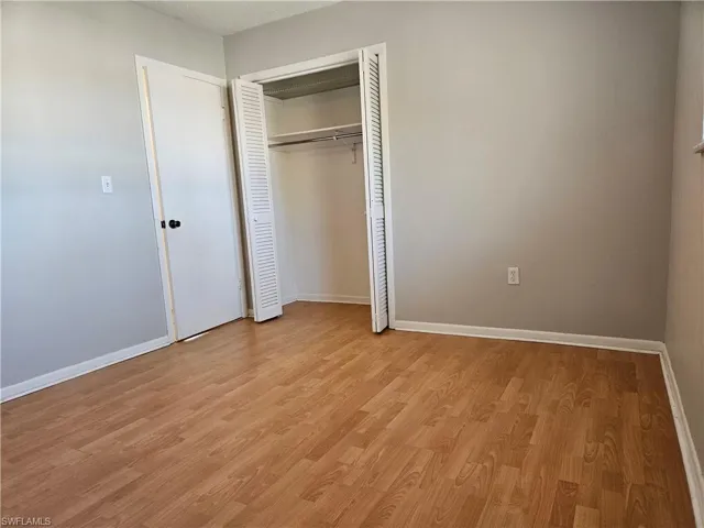 Unfurnished bedroom with light hardwood / wood-style flooring and a textured ceiling