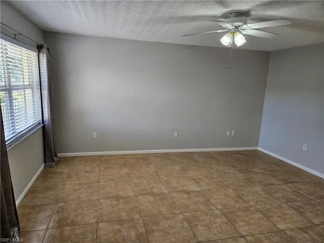 Spare room with ceiling fan and a textured ceiling