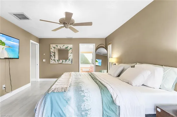 Bedroom featuring ceiling fan and ensuite bath