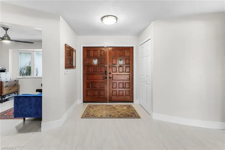 Entrance foyer featuring baseboards and a ceiling fan