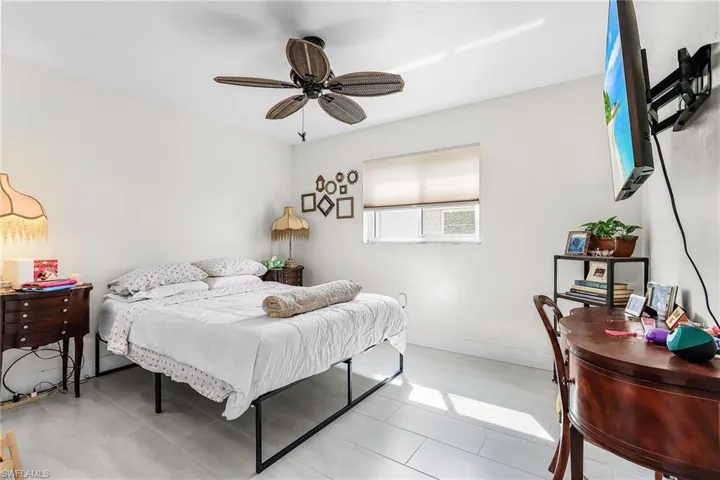 Bedroom with ceiling fan and baseboards
