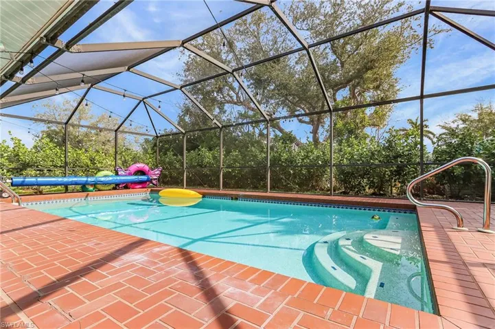 Swimming pool featuring a lanai and a sunroom
