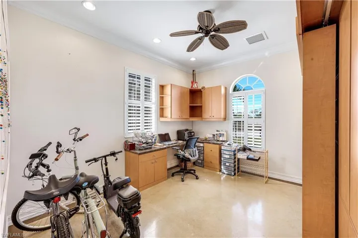 Home office featuring ceiling fan, crown molding, recessed lighting, and finished concrete floors