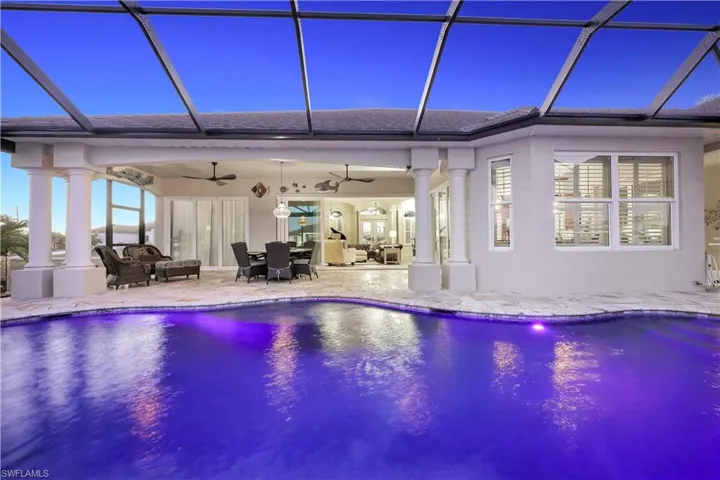Outdoor pool featuring a sunroom, a lanai, a patio, and outdoor lounge area