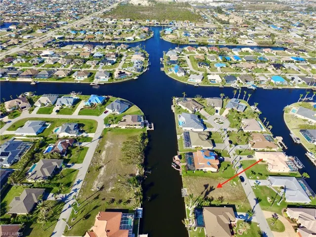 Aerial view of property and surrounding area with nearby suburban area and a nearby body of water