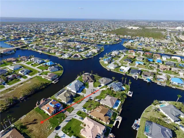 Aerial view of property's location with nearby suburban area