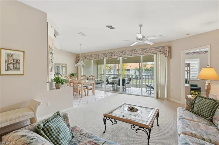 Living area with carpet floors and a ceiling fan