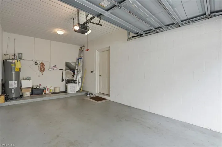 Garage featuring electric water heater