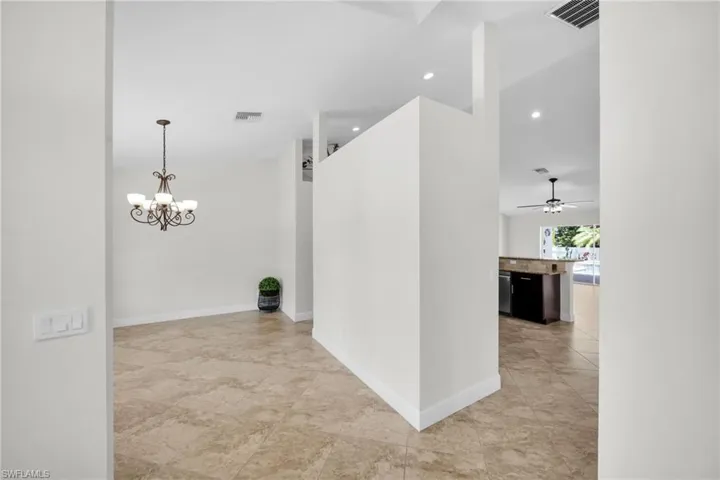 Hall with recessed lighting and a chandelier