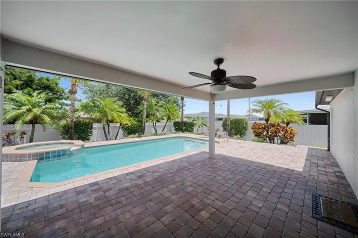 View of swimming pool with a patio, a fenced backyard, ceiling fan, and a pool with connected hot tub