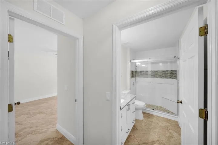 Bathroom featuring vanity, a stall shoíwer, and tile patterned flooring