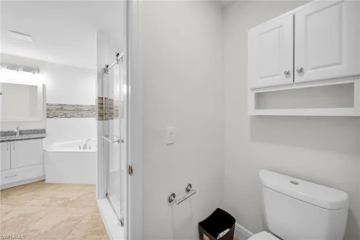 Bathroom with vanity, a stall shower, and a bath