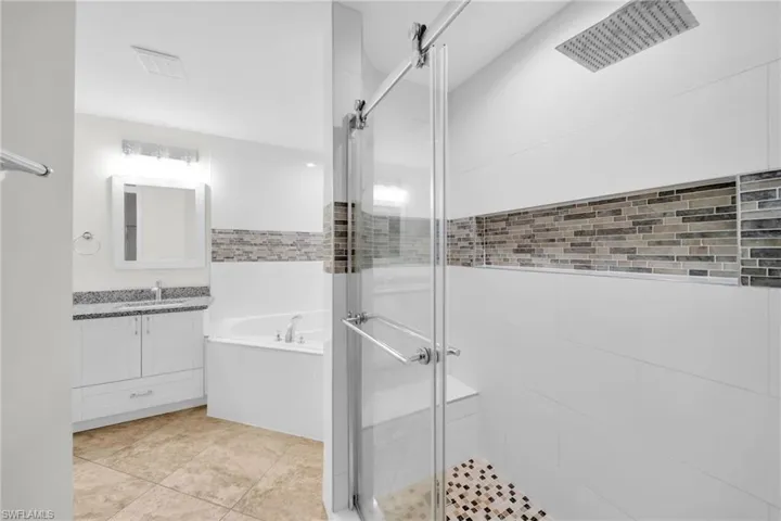 Full bathroom with a garden tub, a shower stall, and vanity