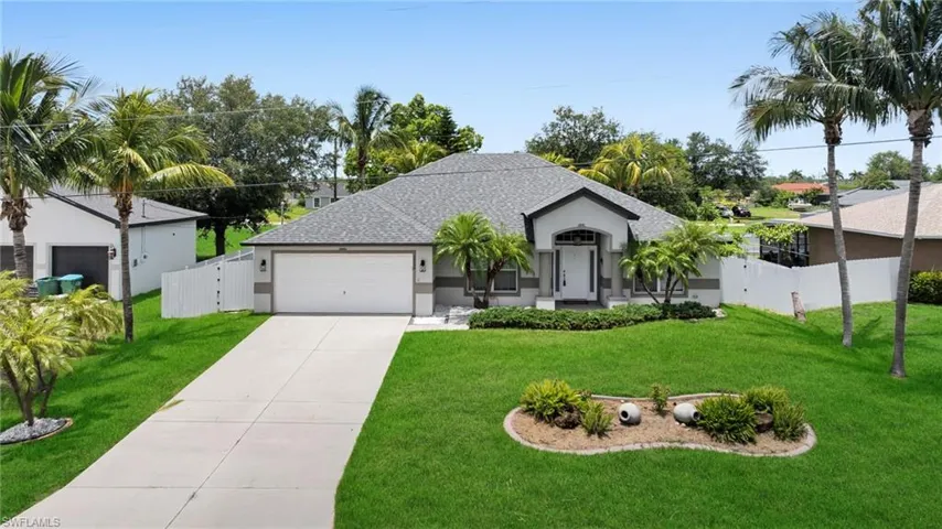 View of front of home featuring stucco siding, a garage, driveway, and roof with shingles